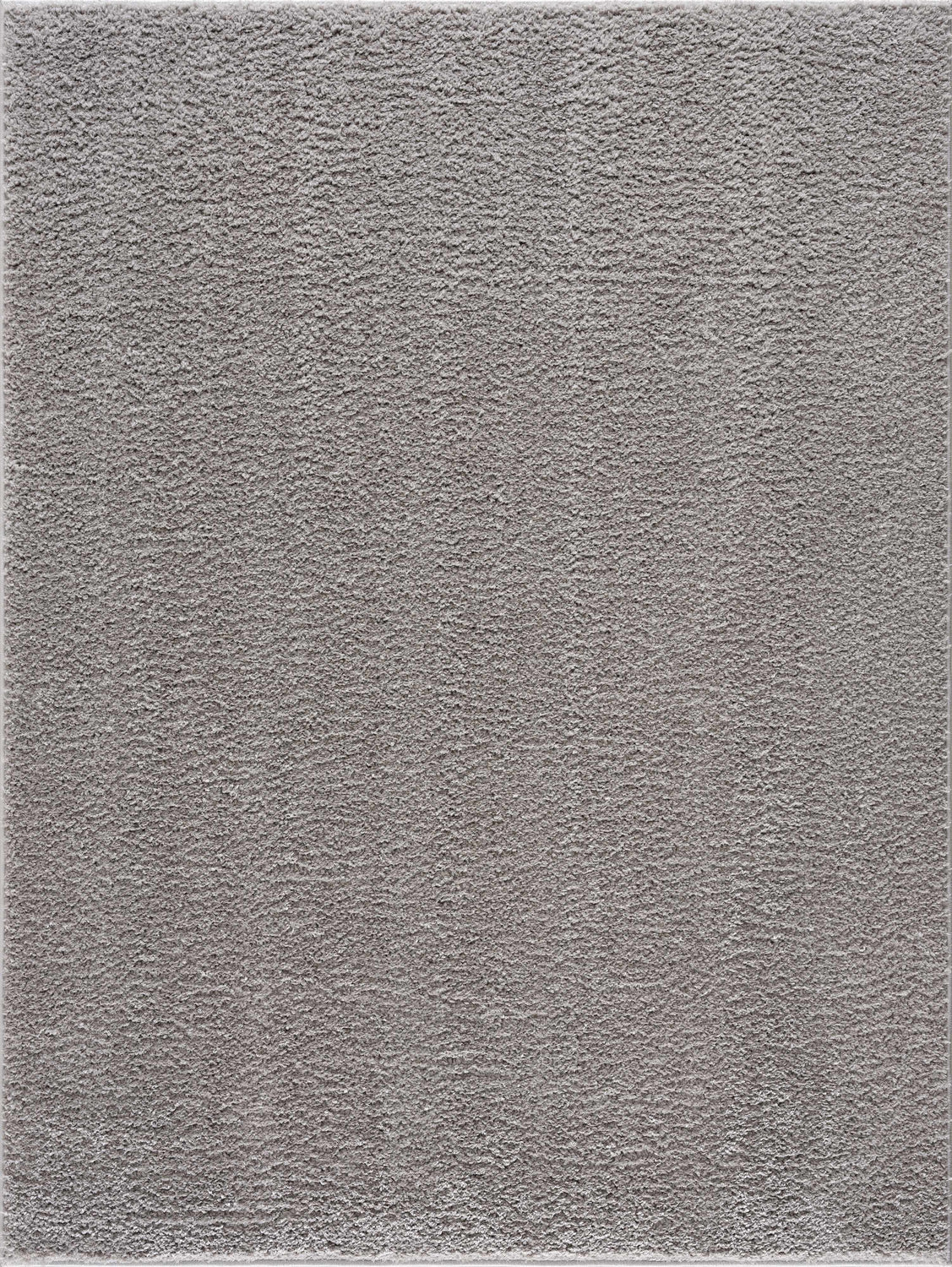 Close-up of the Judy Solid Gray Washable Shag Rug, showing its soft, textured pile and light gray color. Design-Rectangle