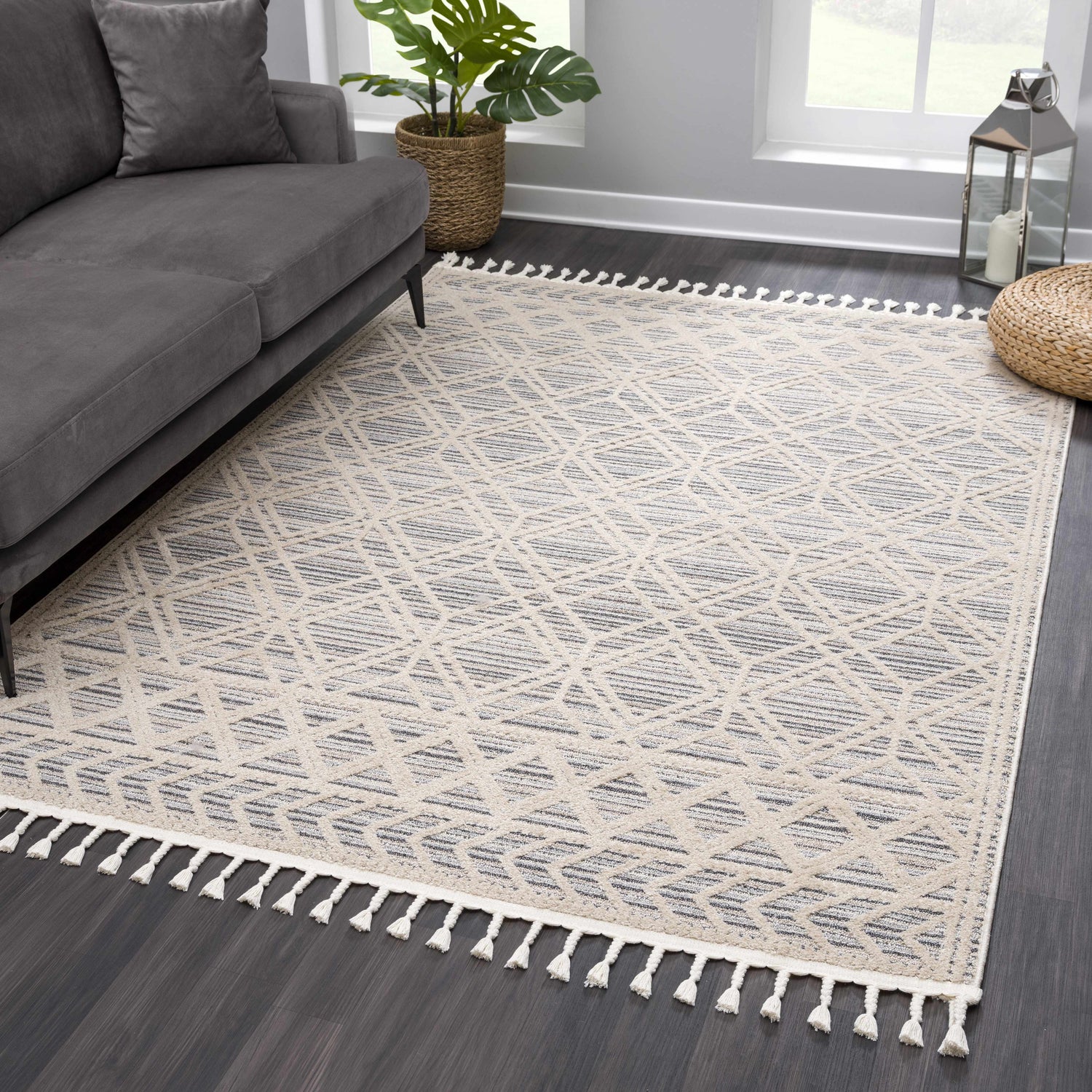 Living room scene with a gray sofa and Magnolia Cream 2300 area rug featuring a geometric pattern and tassel fringe. Roomscene-Rectangle