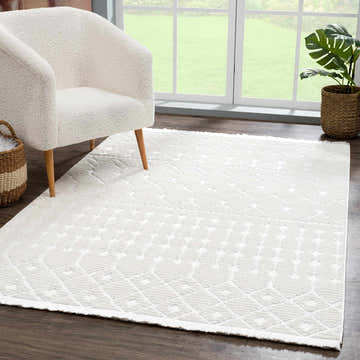 Living room scene with a white sherpa chair on an Ivory Beil 3D Fringe Area Rug. Modern, bright, and inviting. Roomscene-Rectangle