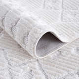 Close-up of the Ivory Beil 3D Fringe Area Rug, showing its geometric pattern, fringe texture, and soft ivory color. Fold