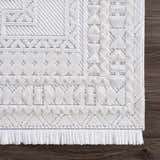 Close up of the Ivory Alya 3D Medallion Fringe Area Rug showing the texture and geometric pattern. Swatch