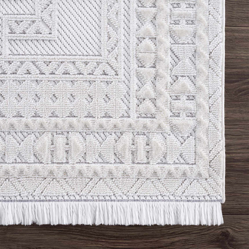 Close up of the Ivory Alya 3D Medallion Fringe Area Rug showing the texture and geometric pattern. Swatch