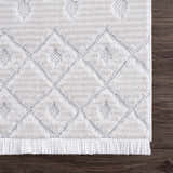 Close-up of the Ivory Beil 3D Fringe Area Rug showing its geometric pattern, fringe detail, and soft, textured ivory pile. Swatch