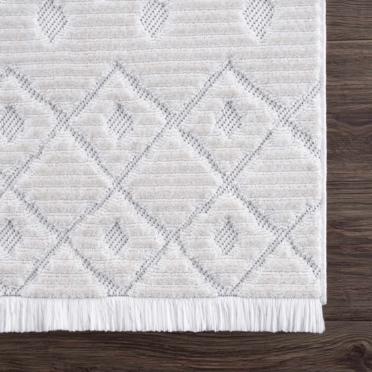 Close-up of the Ivory Beil 3D Fringe Area Rug showing its geometric pattern, fringe detail, and soft, textured ivory pile. Swatch