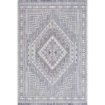 Close-up of the Alya 3D Saxony Area Rug. Gray, light gray, and white geometric pattern with fringe. Design-Rectangle