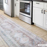 Kitchen scene with a Baltinglass Flat Pile Washable Rug runner in blue, cream, and beige. White cabinets and stainless steel appliances. Roomscene-Runner