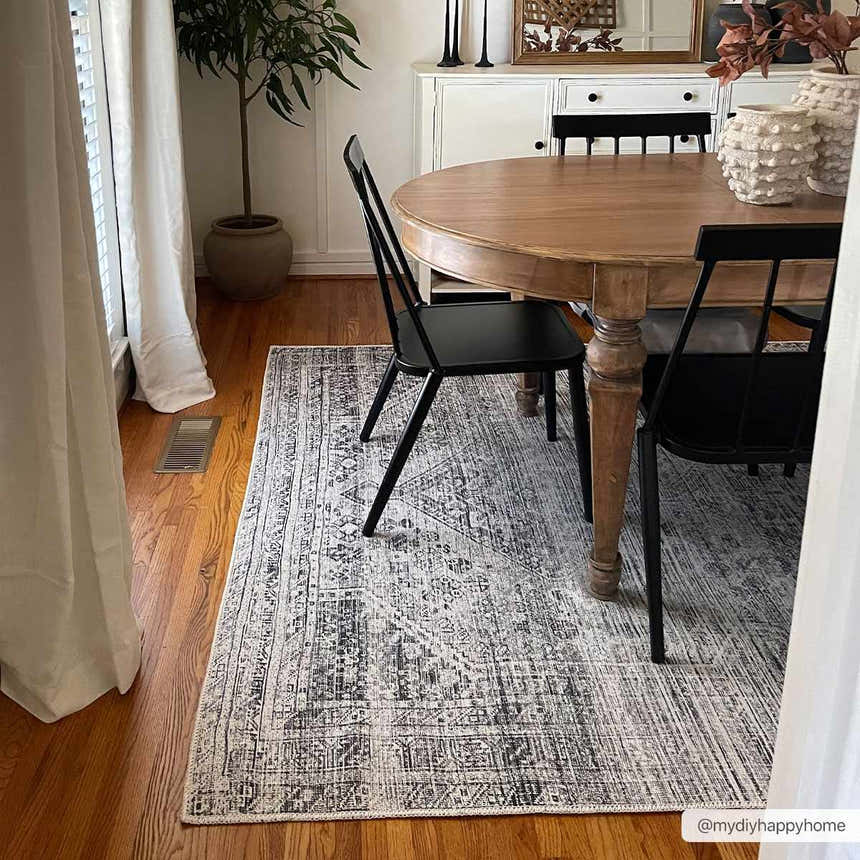 Dining room with wood table and black chairs on Barny Gray Blue Washable Rug. Farmhouse style. Roomscene-Rectangle