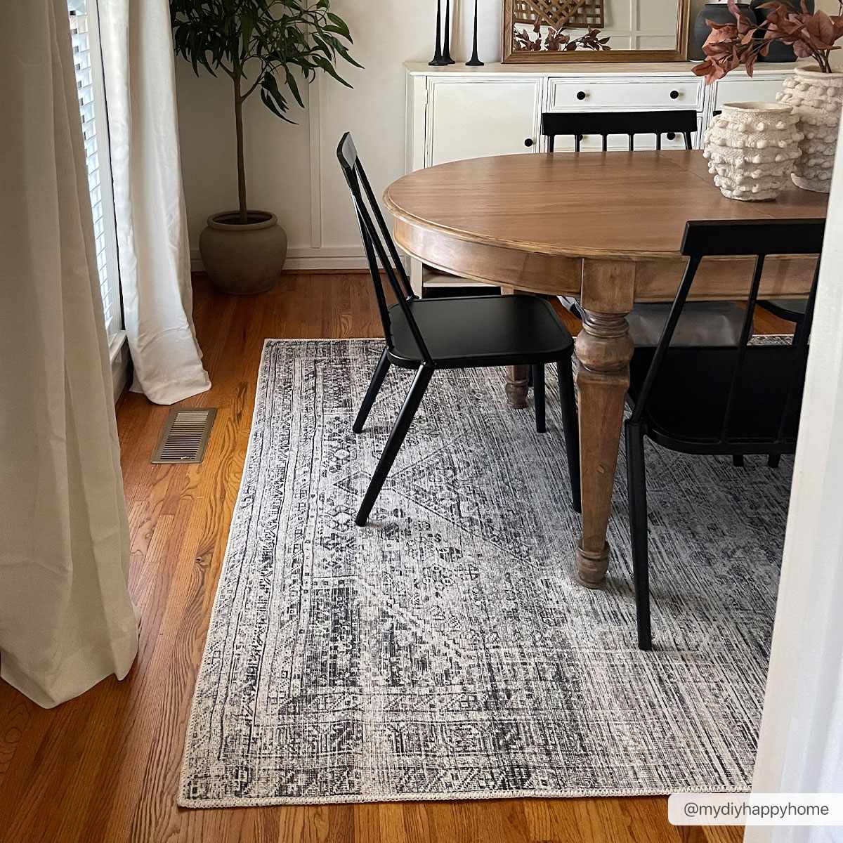 Dining room with wood table and black chairs on Barny Gray Blue Washable Rug. Farmhouse style. Roomscene-Rectangle
