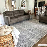 Farmhouse living room with Barny Gray Blue Washable Rug, gray sofa, and rustic decor. Neutral tones create a cozy, inviting space. Roomscene-Rectangle