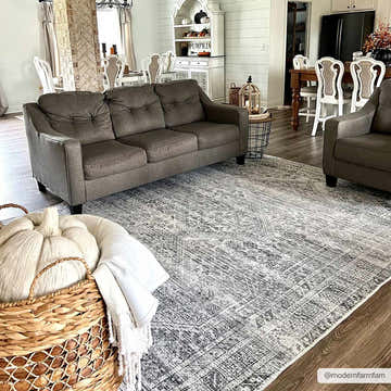 Farmhouse living room with Barny Gray Blue Washable Rug, gray sofa, and rustic decor. Neutral tones create a cozy, inviting space. Roomscene-Rectangle