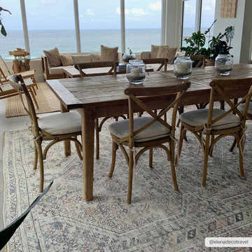 Coastal dining room with a rustic wood table and the Barny Tan Washable Area Rug in black, gray, and peach tones. Roomscene-Rectangle