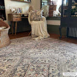 Farmhouse-style room featuring the Barny Tan Washable Area Rug. The rug has a traditional pattern in black, gray, and peach tones. Roomscene-Rectangle
