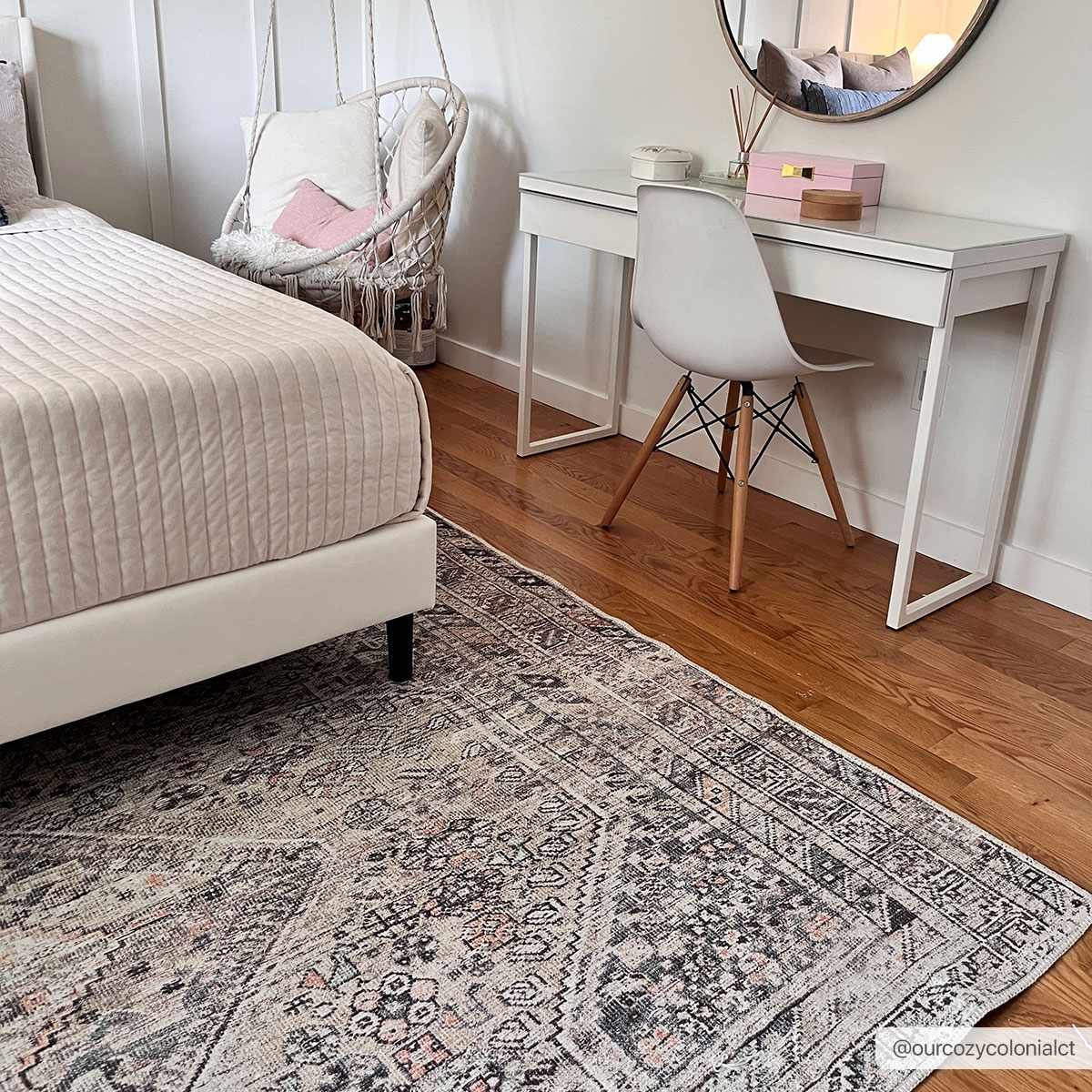Bedroom scene with Barny Tan Washable Area Rug. Features a bed, desk, hanging chair, and traditional rug with black, gray, and peach tones. Roomscene-Rectangle