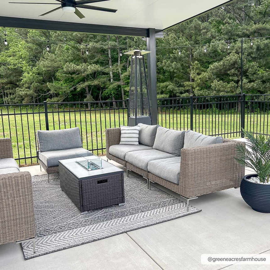 Outdoor patio scene with gray wicker furniture on the Areli Beige / Brown Outdoor Rug. Roomscene-Rectangle