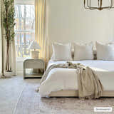 Neutral bedroom scene with a beige Bethany Vintage Flat Pile Washable Rug under a bed with white linens. Roomscene-Rectangle
