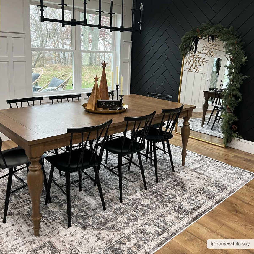Farmhouse dining room with a gray Bevin Washable Area Rug, wood table, black chairs, and black herringbone accent wall. Roomscene-Rectangle