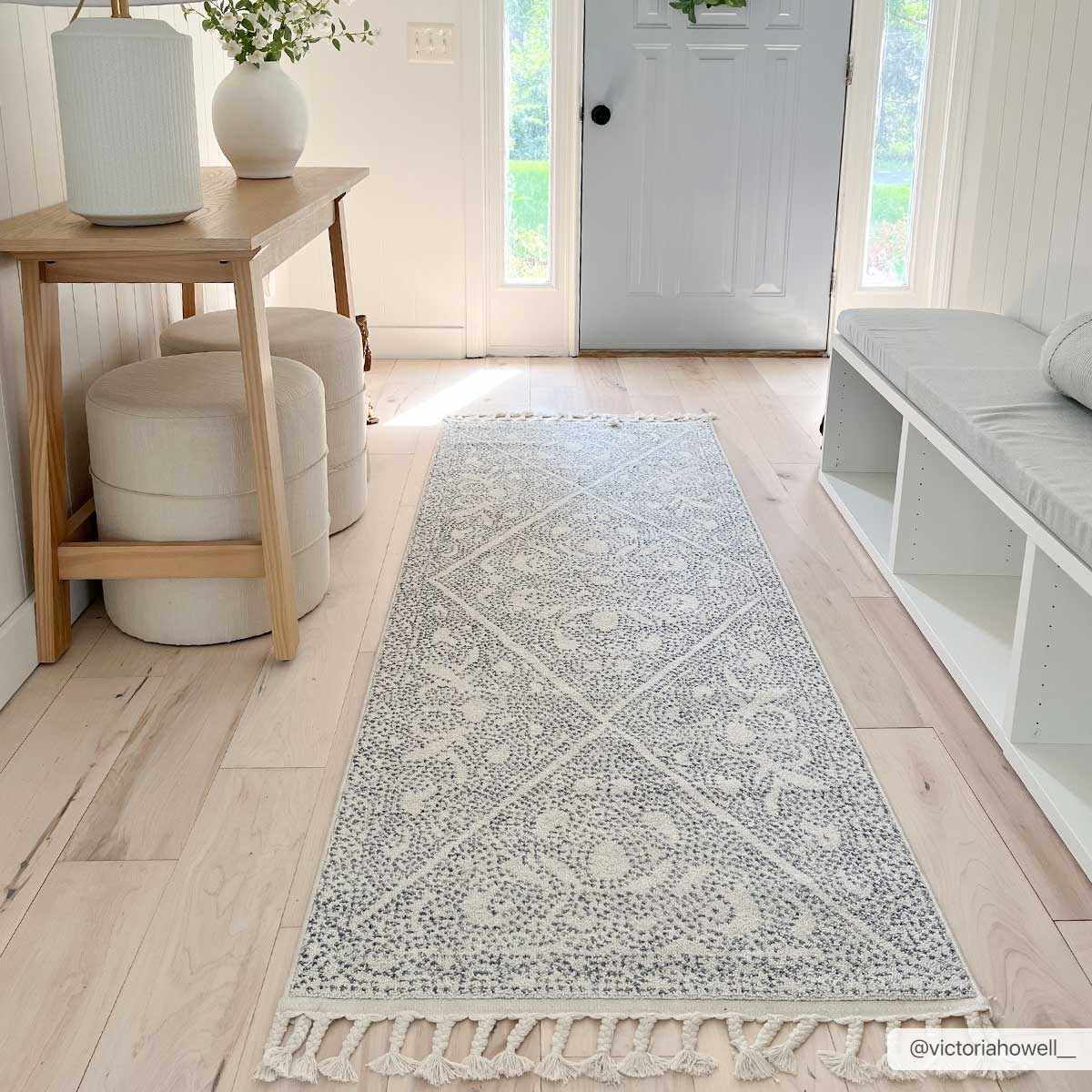 Light and airy entryway with a Birdwood Navy Area Rug runner, wood floors, and white furniture. Roomscene-Runner