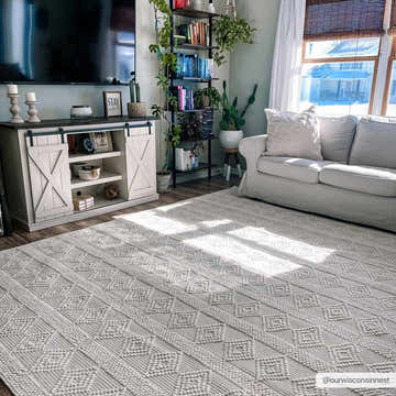 Bright living room with white sofa and Bolinger Wool Area Rug. The rug has a geometric pattern and textured weave. Roomscene-Rectangle