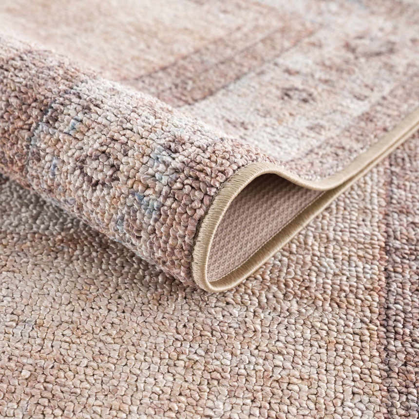 Close-up of the tan Analu Non-Slip Washable Rug showing its texture, backing, and traditional pattern. Fold
