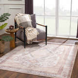 Living room scene with a rustic vintage Analu Non-Slip Washable Rug, gray chair, and side table with plant. Brown, tan, and light blue tones. Roomscene-Rectangle