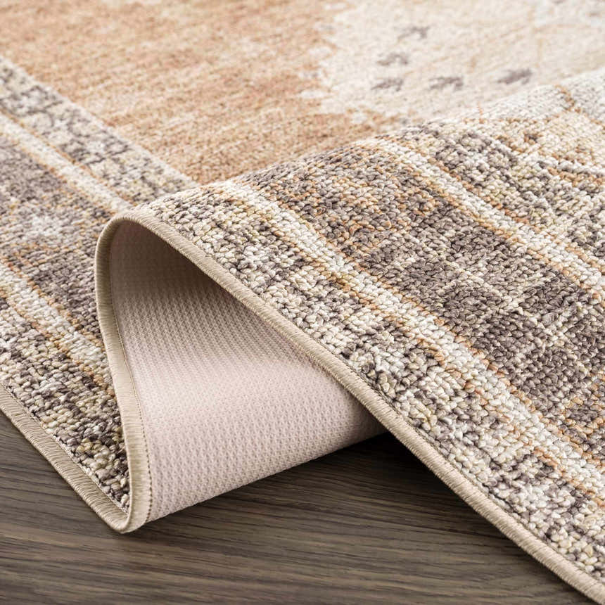 Close-up of the Albas Washable Area Rug showing its light brown, dark brown, and light blue traditional vintage pattern and texture. Fold