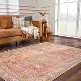 Living room scene with a brown couch and the Anshu Peach Washable Area Rug displaying a traditional vintage design. Roomscene-Rectangle