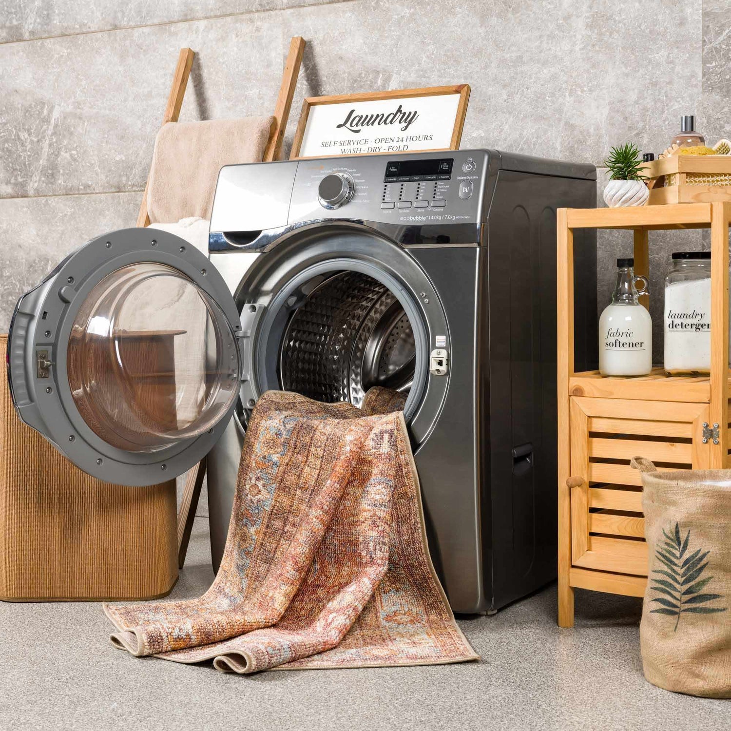 Anshu Peach Washable Area Rug in a bright laundry room with a washing machine and wooden storage. Washing-Machine