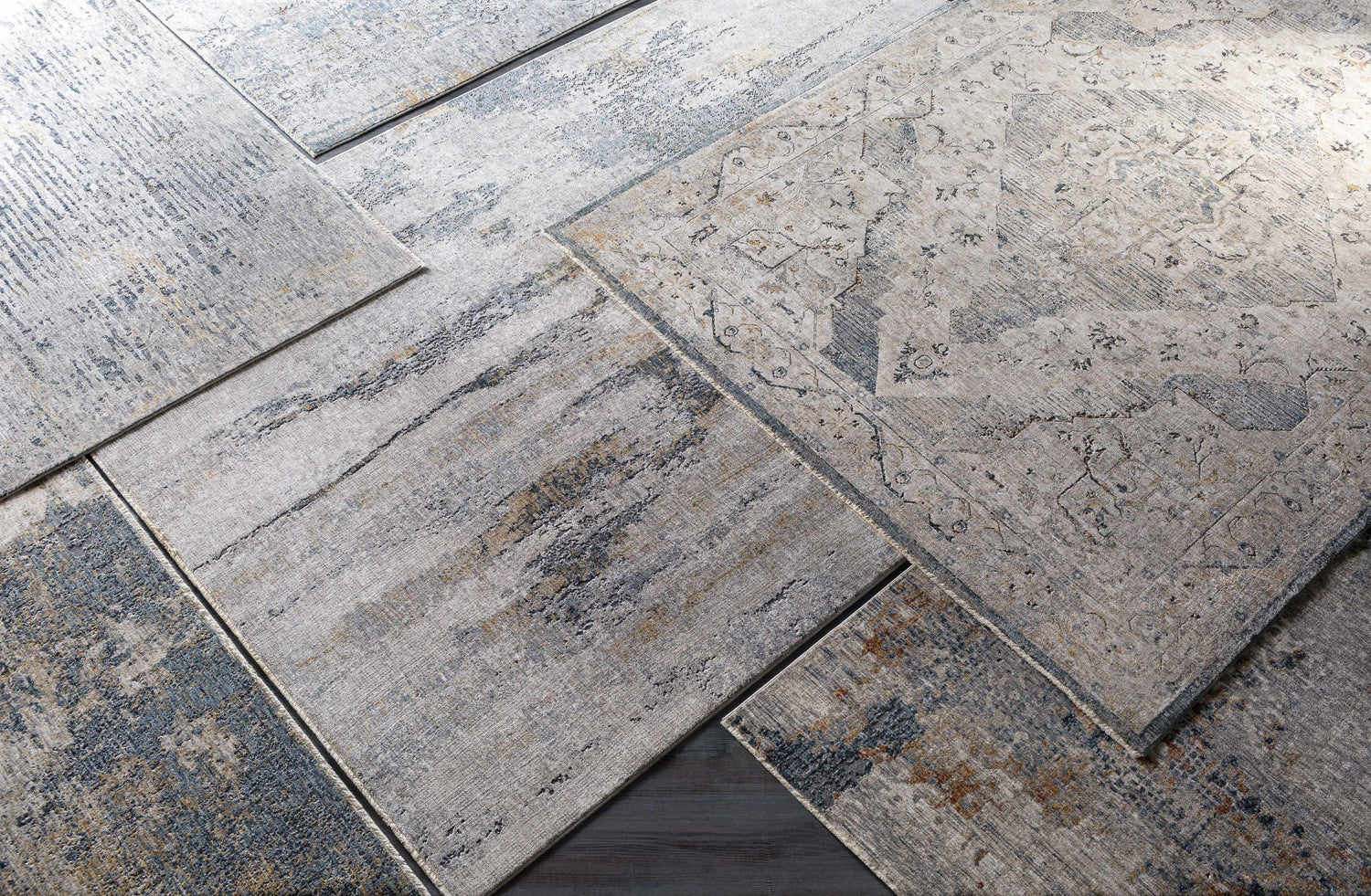 Close-up of Sywell Luxe Fringe Rug in beige, blue, and charcoal. Contemporary polyester rug with a distressed, vintage-inspired design. Styleshot