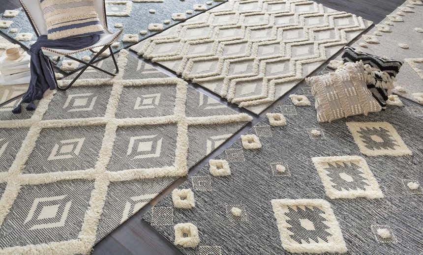 Curllsville Area Rugs in cream and navy. Hand-tufted wool rugs with geometric patterns and a soft, textured pile. Styleshot