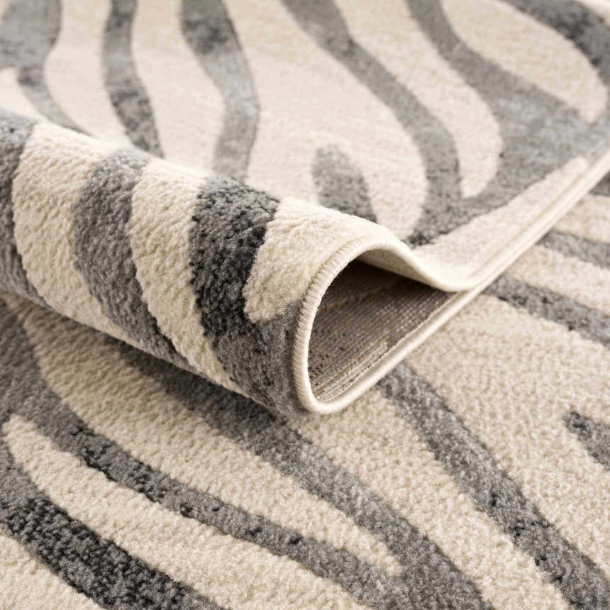Close-up of the Gray Ecorse Zebra Print Area Rug showing the texture and gray and beige zebra pattern. Fold