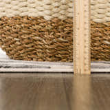 Close-up of the Gray Ecorse Zebra Print Area Rug showing the pile height with a ruler and a woven basket. Pile