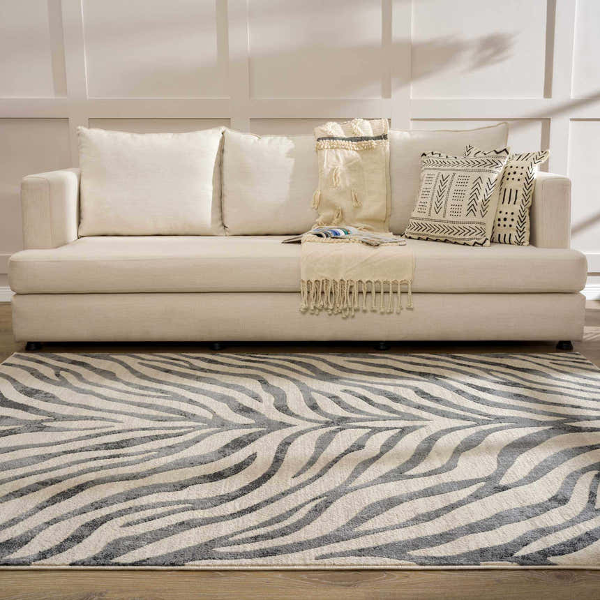 Living room with beige sofa and Gray Ecorse Zebra Print Area Rug. Modern animal print rug. Roomscene-Rectangle