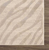 Close-up of the Beige Manteca Zebra Print Area Rug showing its light beige and gray animal pattern and soft texture. Swatch