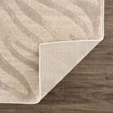 Close-up of Beige Manteca Zebra Print Area Rug showing the light beige and gray animal pattern and rug backing. Fold