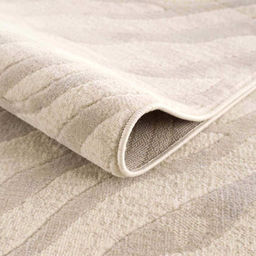 Close-up of the Beige Manteca Zebra Print Area Rug showing its soft texture, beige and light gray pattern, and bound edge. Fold