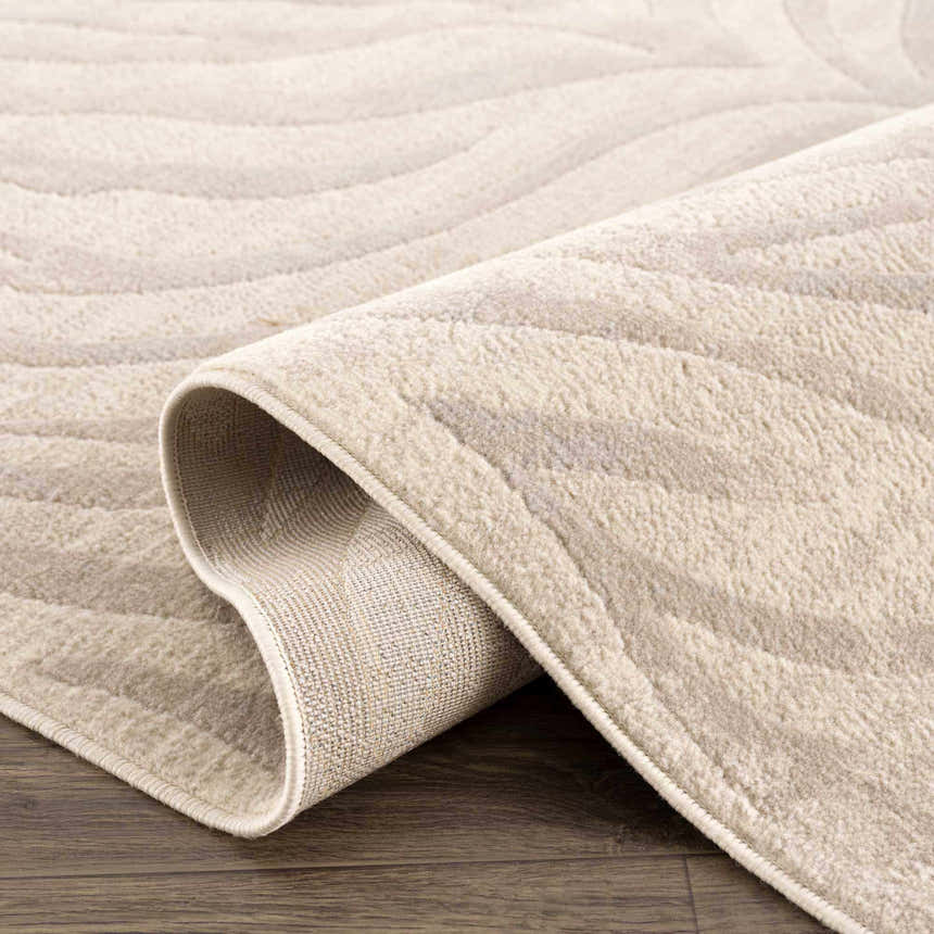 Close-up of the Beige Manteca Zebra Print Area Rug showing its light beige color, soft texture, and machine-woven construction. Fold