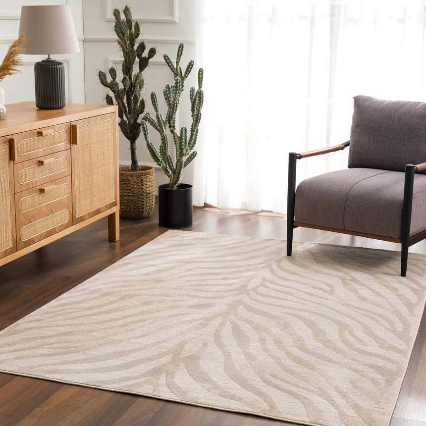 Living room scene with a beige Manteca Zebra Print Area Rug, wood cabinet, cactus, and gray chair. Roomscene-Rectangle