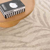 Close-up of the Beige Manteca Zebra Print Area Rug showing its light beige and gray wavy pattern. Styleshot