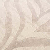 Close-up of the Beige Manteca Zebra Print Area Rug showing its light beige and gray animal pattern and soft, textured weave. Texture