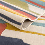 Close-up of the Southfields Colorful Modern Area Carpet showing its texture, colors (aqua, mustard, charcoal, peach), and machine-woven construction. Fold