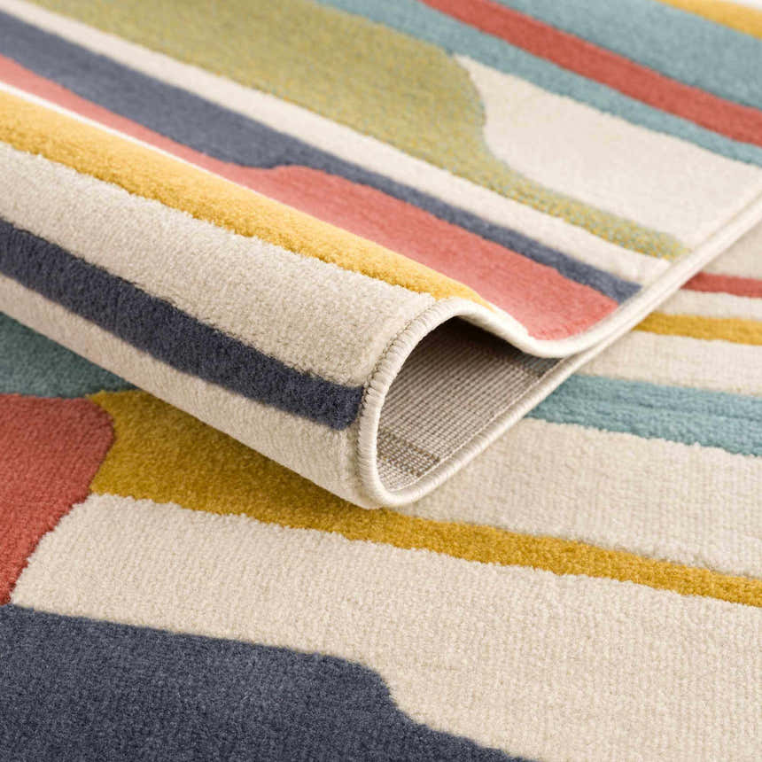 Close-up of the Southfields Colorful Modern Area Carpet showing its texture, colors (aqua, mustard, charcoal, peach), and machine-woven construction. Fold