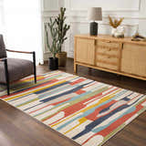 Living room scene with a Southfields Colorful Modern Area Carpet, gray armchair, and wood cabinet. Roomscene-Rectangle