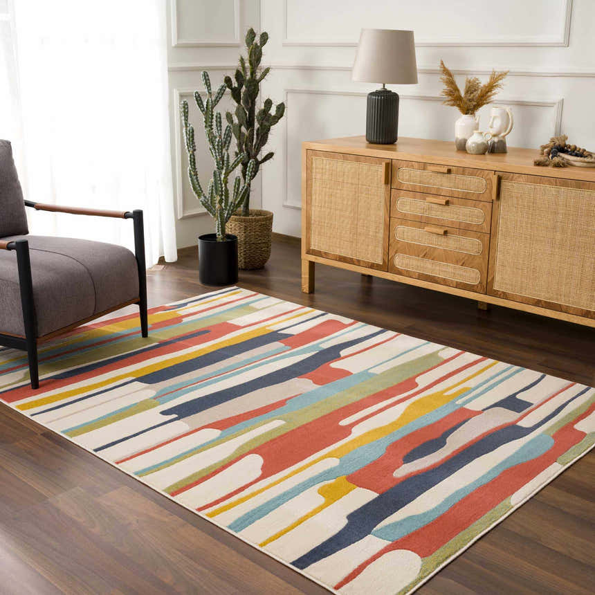 Living room scene with a Southfields Colorful Modern Area Carpet, gray armchair, and wood cabinet. Roomscene-Rectangle
