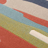 Close-up of Southfields Colorful Modern Area Carpet showing texture and colors: aqua, charcoal, peach, mustard, and beige. Texture