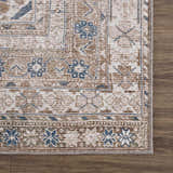 Close-up of the Baltinglass Flat Pile Washable Rug. Features a traditional oriental pattern in blue, cream, and beige tones. Swatch