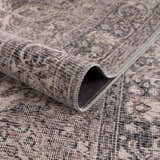 Close-up of the Greenpoint Dusty Blue Washable Rug showing its chenille texture and vintage-inspired oriental pattern. Fold