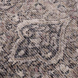 Close-up of the Greenpoint Dusty Blue Washable Rug, showcasing its beige, black, and red oriental-style pattern and chenille texture. Texture
