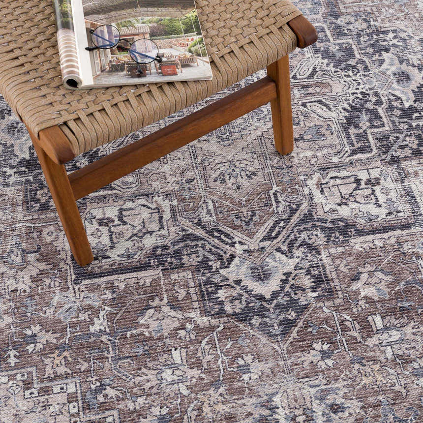 Close-up of the Abner Washable Area Rug showing its brown, charcoal, and ivory traditional pattern and soft chenille texture. Styleshot