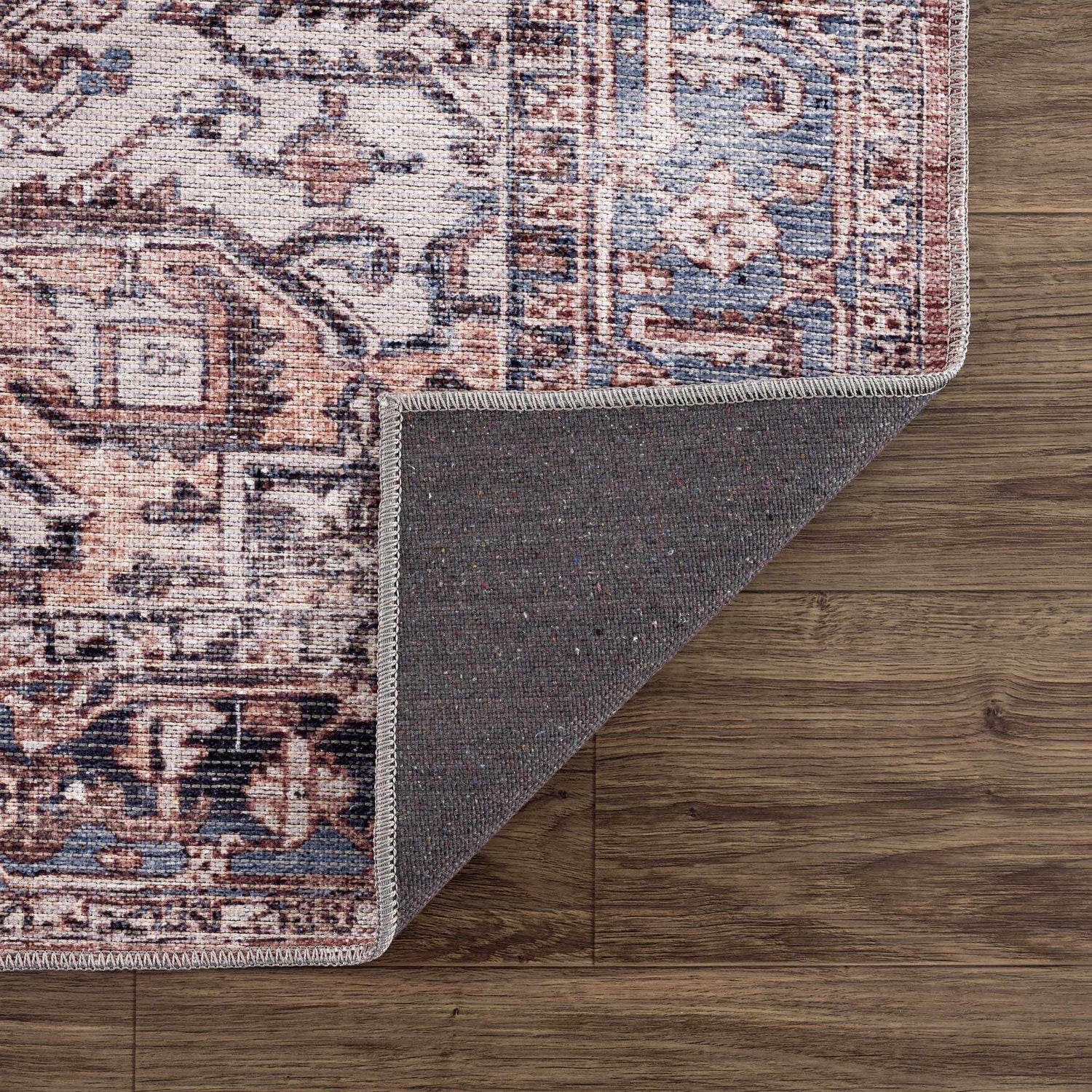 Close-up of Viho Vintage Flat Pile Washable Rug showing its brown, blue, and white traditional pattern and chenille texture. Fold