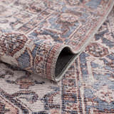 Close-up of the Viho Vintage Flat Pile Washable Rug, showing a traditional pattern in brown, blue, and peach tones. Chenille polyester texture. Fold